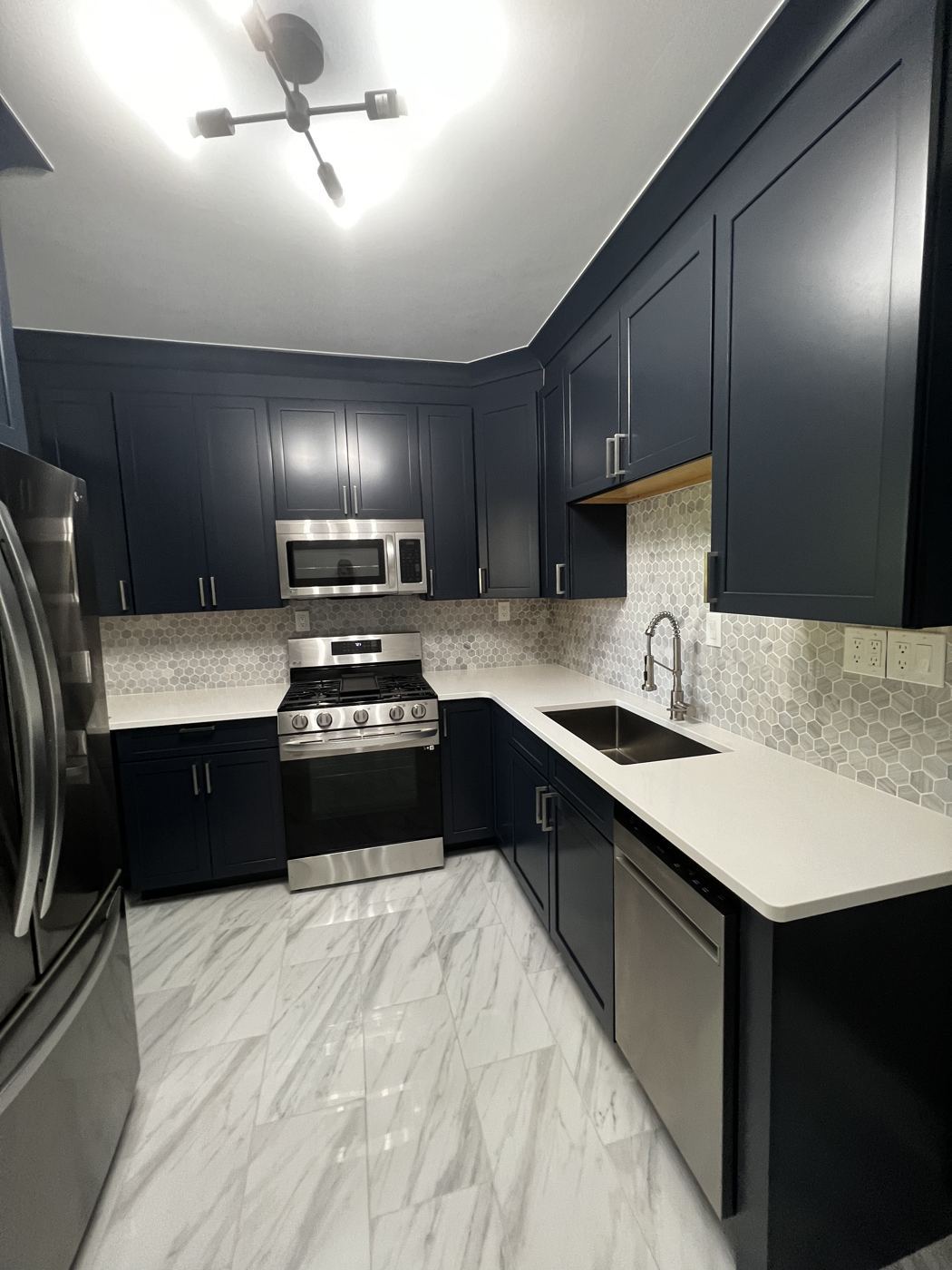 Renovated kitchen with navy cabinets
